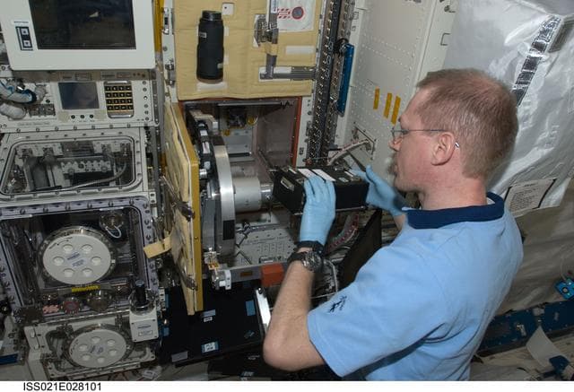 NASA image: Commander De Winne works on the RadSilk Experiment in the JPM
