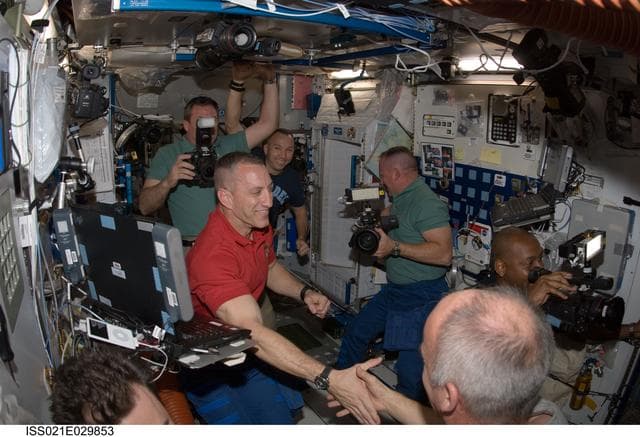 NASA image: STS-129 and Expedition 21 Crew Members greet one another
