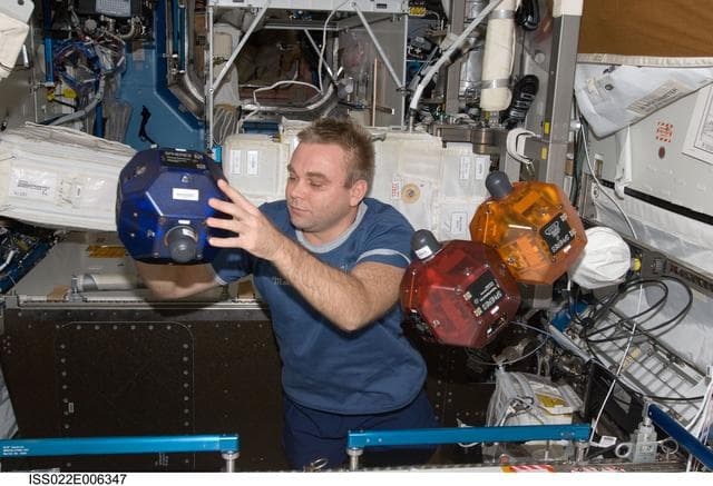 NASA image: Suraev works with SPHERES in the U.S. Laboratory during Expedition 22