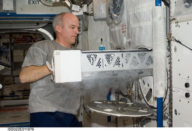 NASA image: Williams installs the APXC Payload in MELFI during Expedition 22
