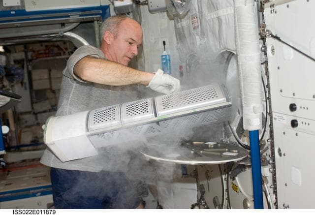 NASA image: Williams installs the APXC Payload in MELFI during Expedition 22