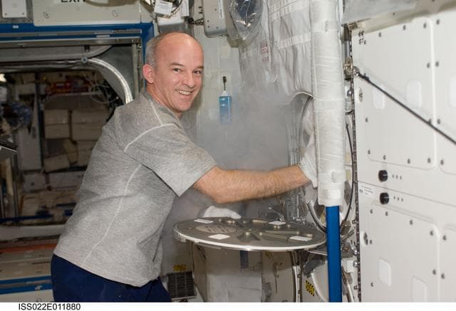 NASA image: Williams installs the APXC Payload in MELFI during Expedition 22
