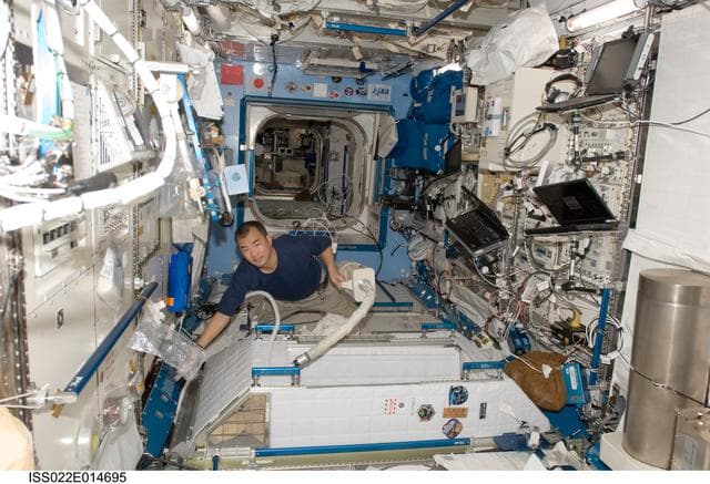NASA image: Noguchi uses vacuum cleaner in the JPM during Expedition 22