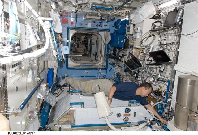 NASA image: Noguchi uses vacuum cleaner in the JPM during Expedition 22