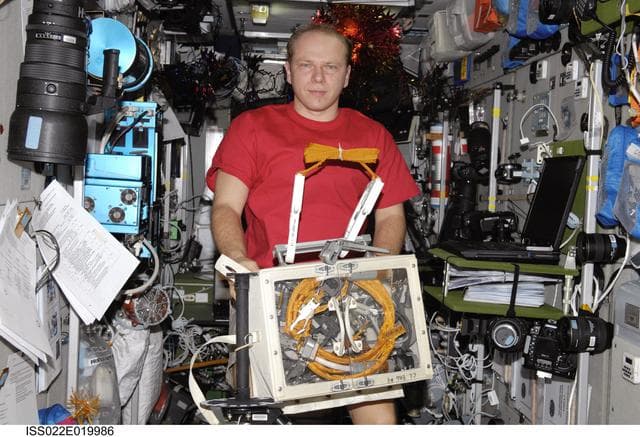 NASA image: Kotov holds Retractable Equipment Tethers in the SM during Expedition 22