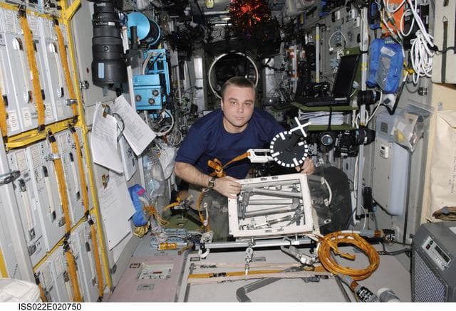 NASA image: Creamer looks through EVA Equipment in the SM during Expedition 22