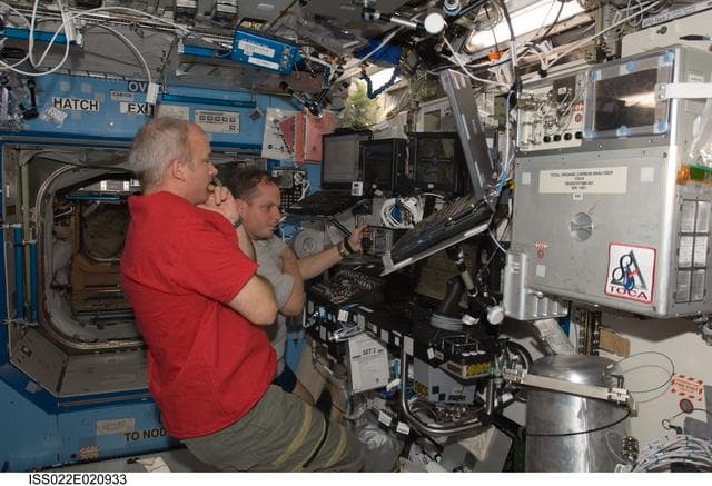 NASA image: Williams and Creamer at SSRMS controls in the U.S. Laboratory during Expedition 22