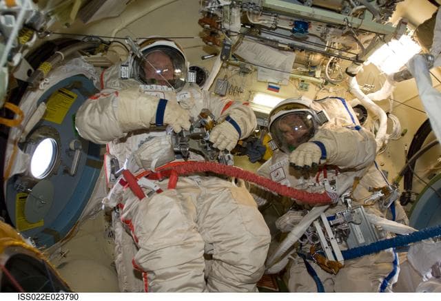 NASA image: Kotov and Suraev wearing Russian Orlan Spacesuits in the Pirs DC-1 during Expedition 22