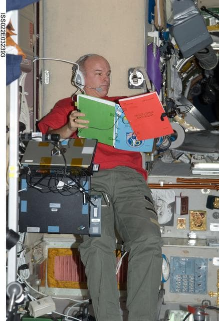 NASA image: Williams looks at crew procedures in the SM during Expedition 22