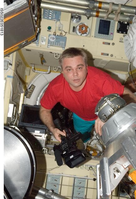NASA image: Suraev holds camera in the Transfer Compartment of the SM during Expedition 22
