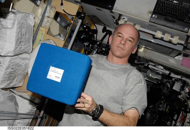 NASA image: Williams holding Foam Casting Pouch in the SM during Expedition 22