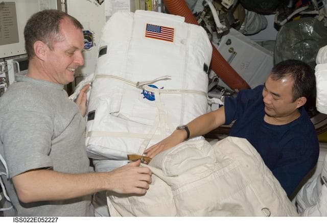NASA image: Creamer and Noguchi works on EMU in the A/L during Expedition 22