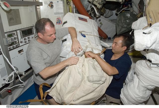 NASA image: Creamer and Noguchi works on EMU in the A/L during Expedition 22