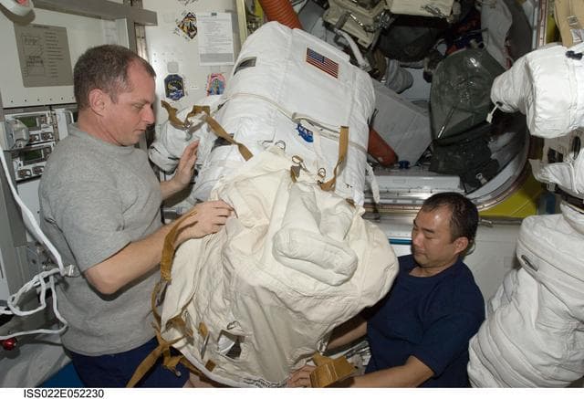 NASA image: Creamer and Noguchi works on EMU in the A/L during Expedition 22