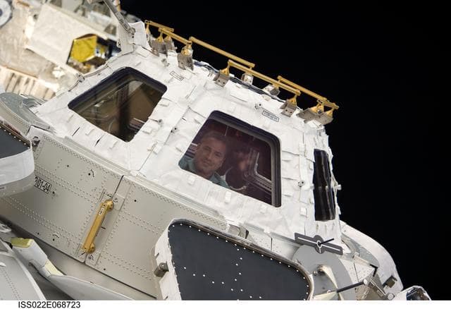 NASA image: Zamka at window in the Cupola Module during Joint Operations