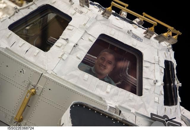 NASA image: Zamka at window in the Cupola Module during Joint Operations