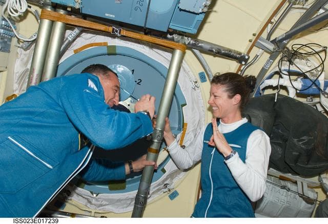 NASA image: Skvortsov and Dyson in MRM2 following Soyuz TMA-18/22S Hatch Opening