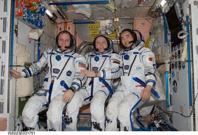 NASA image: Creamer, Kotov and Noguchi prepare for Sokol Suit Leak Check