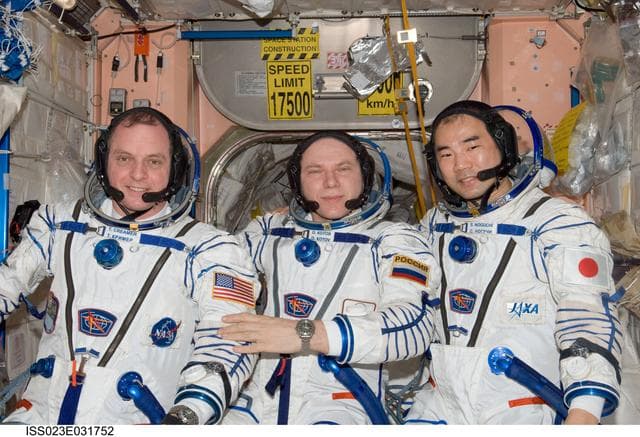 NASA image: Creamer, Kotov and Noguchi prepare for Sokol Suit Leak Check