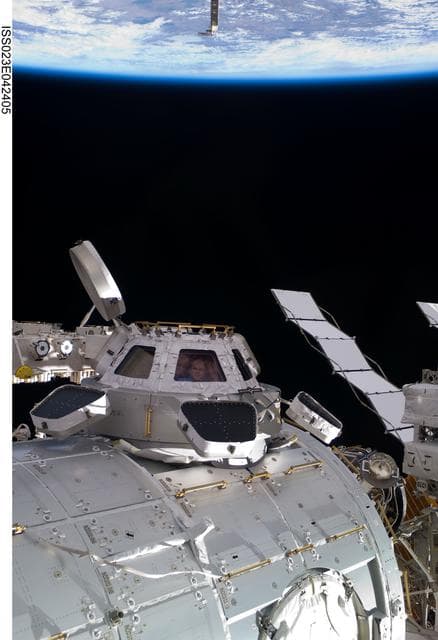 NASA image: View of Creamer, Kotov and Noguchi in a Cupola Window