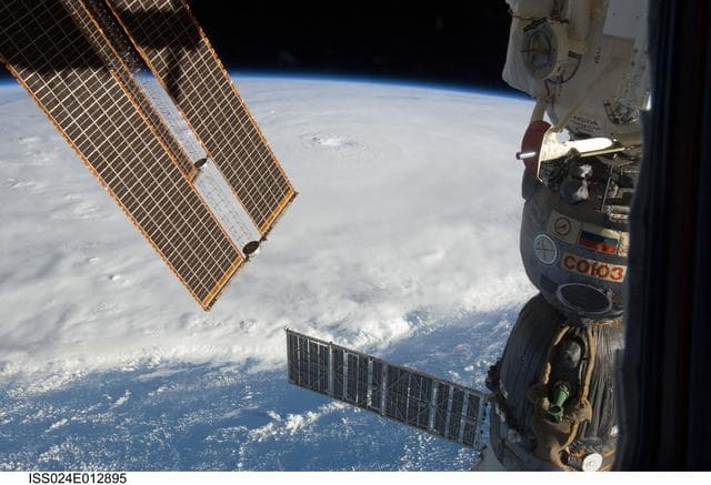 NASA image: View of Soyuz Spacecraft backdropped by Hurricane Earl