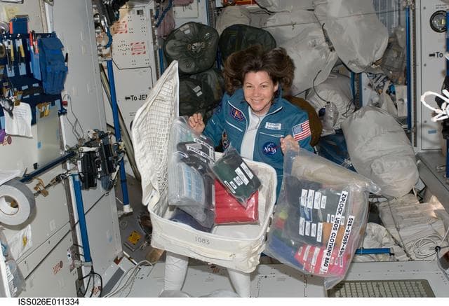 NASA image: Coleman poses with stowage container in the Node 2