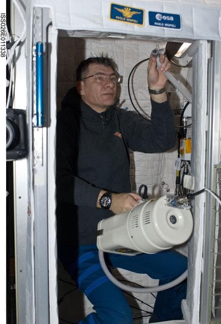 NASA image: Nespoli uses vacuum cleaner in the Node 2