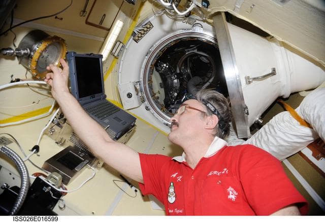 NASA image: Kaleri looks at the Absolute Pressure Gauge in the MRM-2 during Expedition 26
