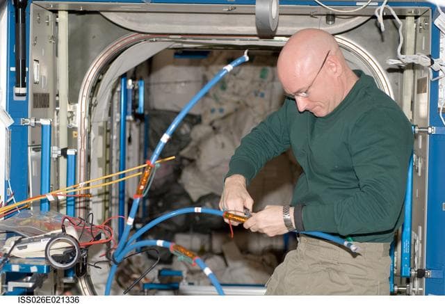 NASA image: Kelly works with cables