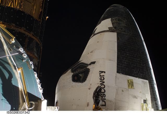 NASA image: Columbus Module and STS-133 Space Shuttle Discovery FWD Cabin during EVA