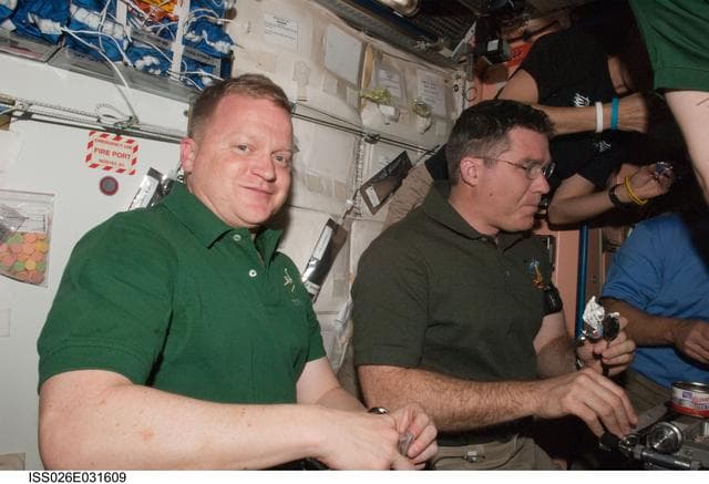NASA image: Boe and Bowen enjoy a meal in the Node 1