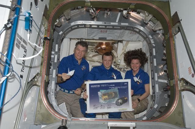 NASA image: Expedition 27 Crew with HTV2 Poster and Paper Cranes