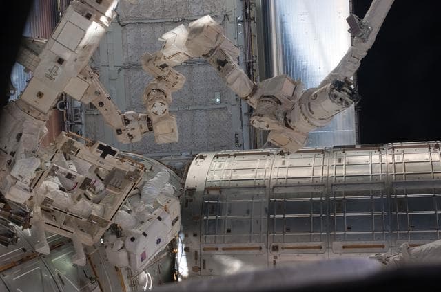 NASA image: View of STS-134 MS Feustel and Fincke working during EVA-3