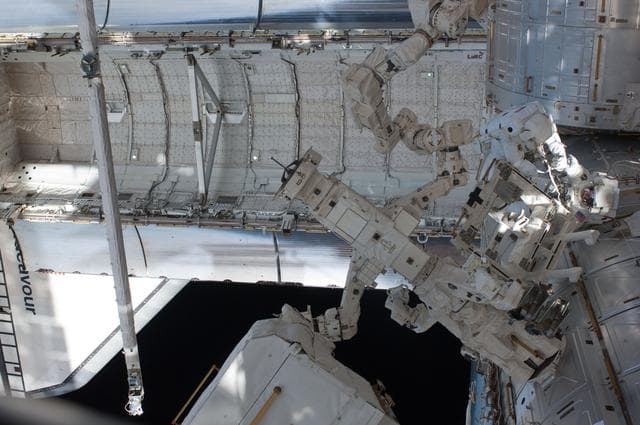 NASA image: View of STS-134 MS Feustel and Fincke working during EVA-3