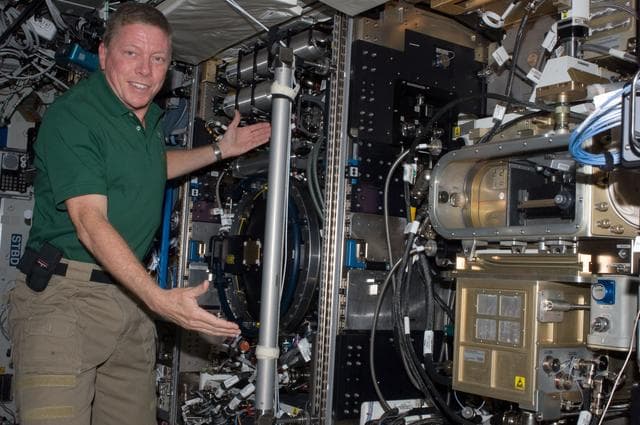 NASA image: Expedition 28 FE Fossum poses for a photo next to the CIR in US Lab