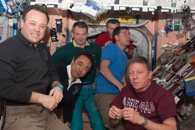 NASA image: Expedition 28 crew members enjoy dinner in the Node 1
