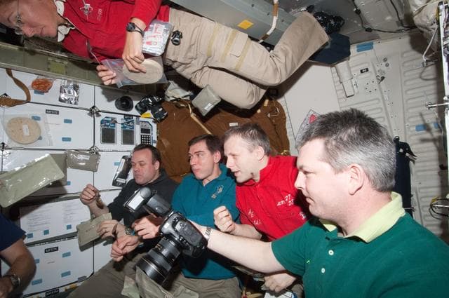 NASA image: STS-135/Expedition 28 Crew Members in Shuttle Middeck