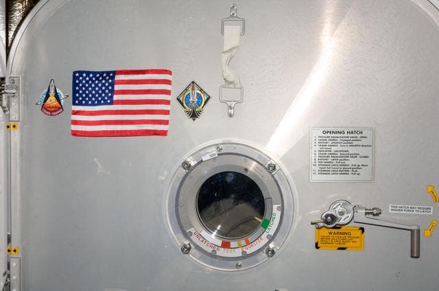 NASA image: American Flag mounted to Node 2 Forward Hatch