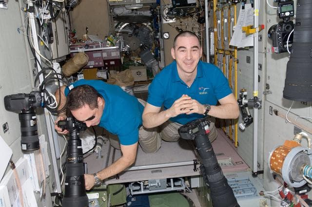 NASA image: Shkaplerov and Ivanishin using still cameras in the SM