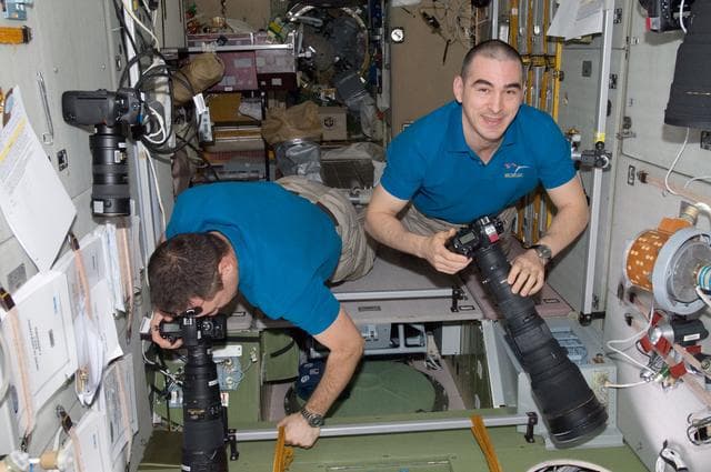NASA image: Shkaplerov and Ivanishin using still cameras in the SM