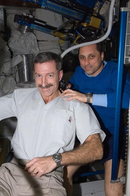NASA image: Shkaplerov trims Burbank's hair in the Node 3