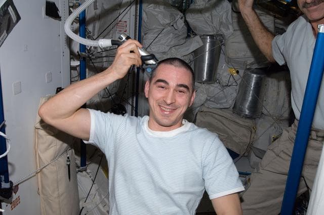 NASA image: Ivanishin trims his hair in the Node 3