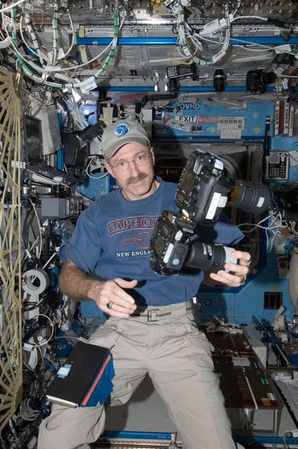 NASA image: Burbank holds still camera in the U.S. Laboraotry