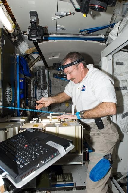 NASA image: Burbank works with the MCA MSA of the Atmosphere Revitalization System