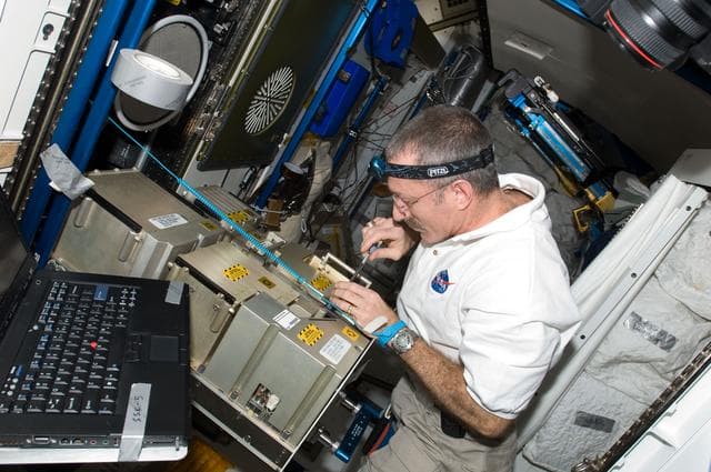 NASA image: Burbank works with the MCA MSA of the Atmosphere Revitalization System