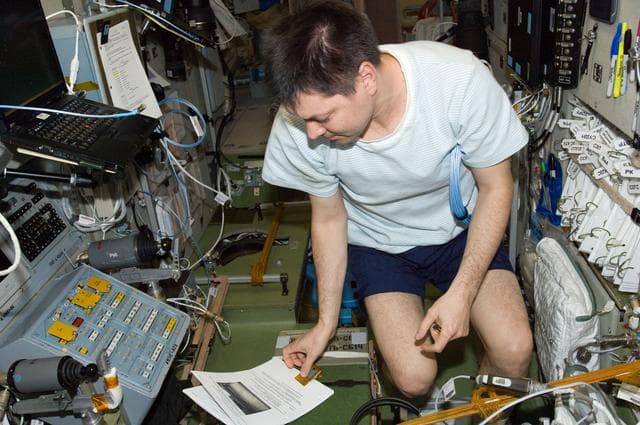 NASA image: Kononenko reads a procedures checklist in the SM