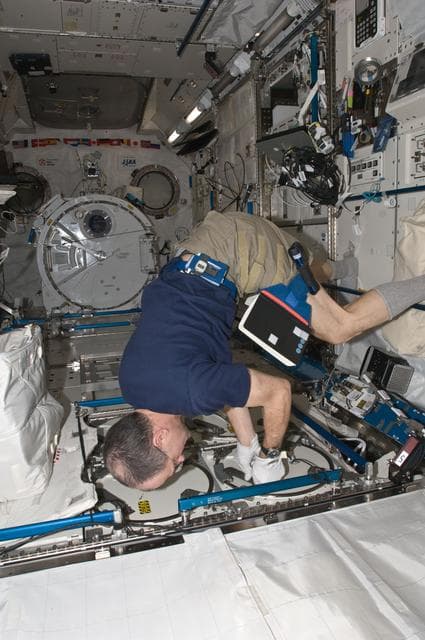 NASA image: Pettit prepares to insert biological samples in the MELFI-1 in the JPM