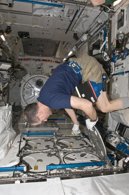 NASA image: Pettit prepares to insert biological samples in the MELFI-1 in the JPM