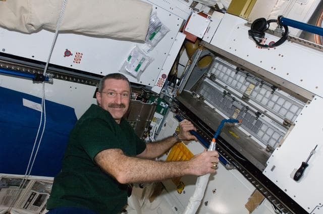 NASA image: Burbank cleans cabin air bacteria filters in the Node 3