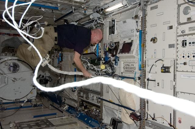 NASA image: Kuipers uses vacuum cleaner in the JPM